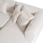 Canapé d'angle quatre places en polyester au design incurvé et surpiqûres larges.