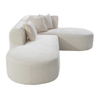 Canapé d'angle quatre places en polyester au design incurvé et surpiqûres larges.