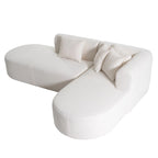 Canapé d'angle quatre places en polyester au design incurvé et surpiqûres larges.