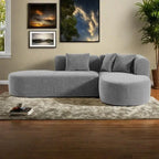 Canapé d'angle quatre places en polyester au design incurvé et surpiqûres larges.