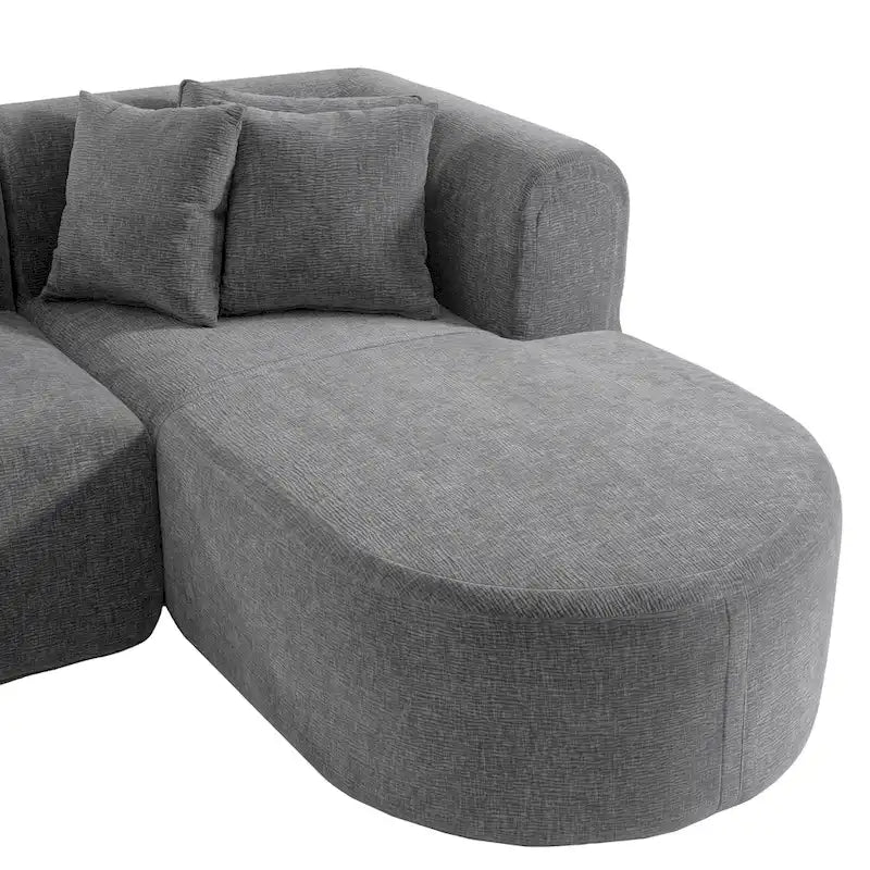 Canapé d'angle quatre places en polyester au design incurvé et surpiqûres larges.