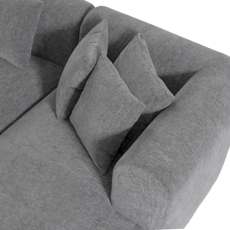 Canapé d'angle quatre places en polyester au design incurvé et surpiqûres larges.