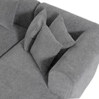 Canapé d'angle quatre places en polyester au design incurvé et surpiqûres larges.