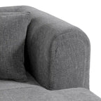 Canapé d'angle quatre places en polyester au design incurvé et surpiqûres larges.