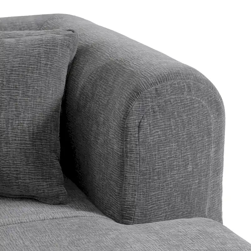 Canapé d'angle quatre places en polyester au design incurvé et surpiqûres larges.
